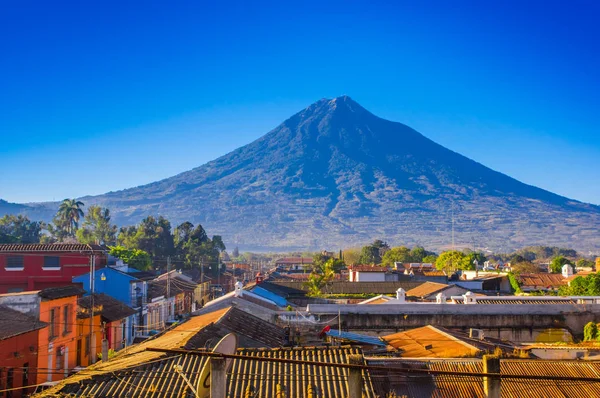 Bela vista ao ar livre dos telhados do edifício na cidade de Antígua com água vulcão montanha atrás em um belo dia ensolarado e céu azul — Fotografia de Stock