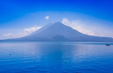 Beautiful landscape of Atitlan Lake, is the deepest lake in all of Central America with a maximum depth of about 340 meters, with volcano in Background clipart