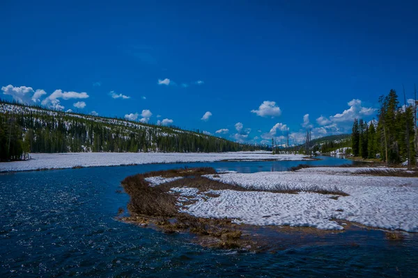 Vista al aire libre del río congelado parcial en el Parque Nacional de Yellowstone con cielo azul — Foto de Stock