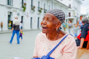 POPAYAN, COLOMBIA - FEBRUARY 06, 2018: Portrait of gorgeous colombian black women smiling and looking somewhere, in the streets of Popayan clipart