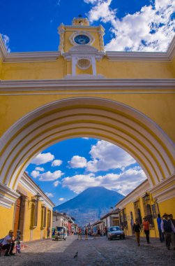 Ciudad de Guatemala, Guatemala, April, 25, 2018: The famous arch of the city center of Antigua together with agua volcano in the horizont, view through the arch clipart