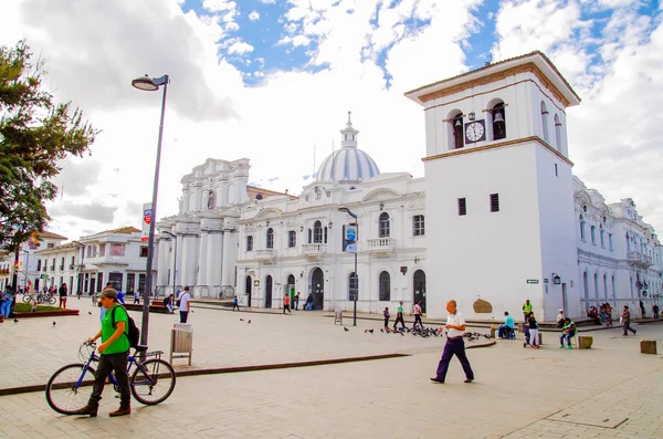 POPAYAN, COLOMBIA - 06 DE FEBRERO DE 2018: Personas no identificadas caminando por el quare frente a la torre del reloj en Popayan, durante un día soleado, magnífico fondo azul del cielo — Foto de Stock