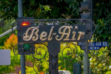 Los Angeles, California, USA, JUNE, 15, 2018: Outdoor view of Bel Air sign in a metallic structure with a building background defocused clipart