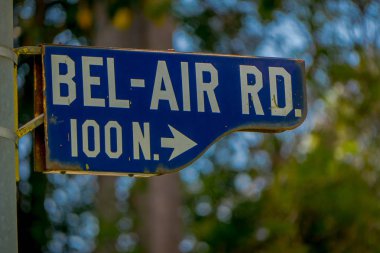 Los Angeles, California, USA, JUNE, 15, 2018: Outdoor view of Bel Air sign in a metallic structure with a building background defocused clipart