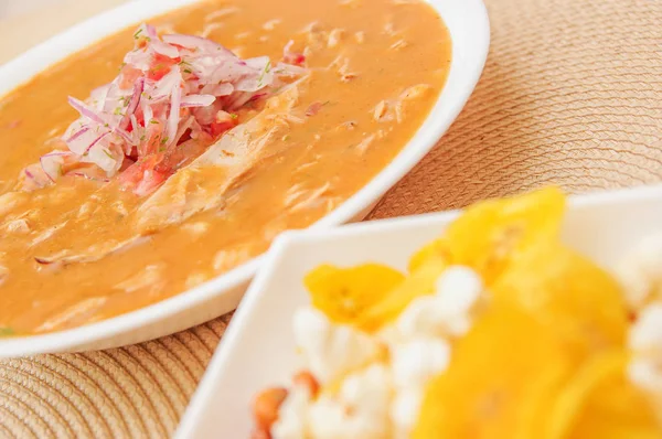 Close up of blurred Banana chips chifles lying in small white bowl with a bowl of encebollado soup behind — Stock Photo, Image