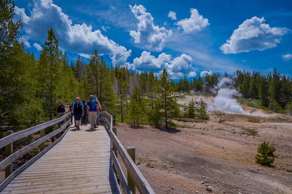 YELLOWSTONE, MONTANA, USA JUNE 02, 2018: Unidentified people taking pictures and enjoying the Pools of colorfully colored water dot of the Norris Geyser Basin in Yellowstone National Park — Stock Photo, Image