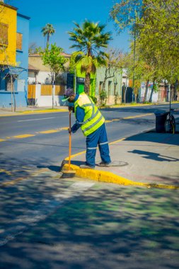 Santiago, Şili - 17 Eylül 2018: Açık görünüm kimliği belirsiz adam üniforma ve Santiago şehir dowtown caddeleri süpürmek