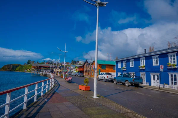 CHILOE, CHILE - SEPTEMBER, 27, 2018: Outdoor view of some cars parked in the street in front of gorgeous chonchi harbour in Chiloe islandm surrounding of beautiful wooden houses in Chile — Stock Photo, Image