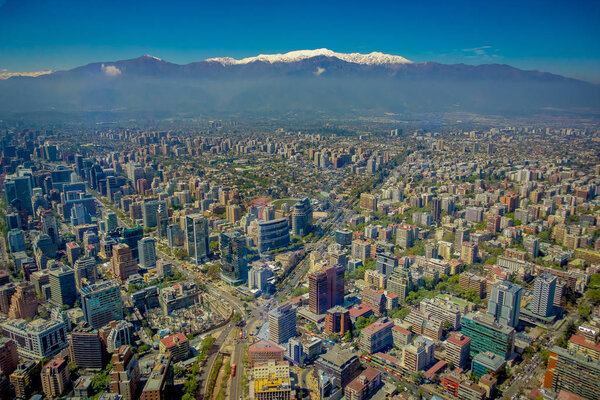 Gorgeous view of Santiago with a snowy mountain in the horizont viewed from Cerro San Cristobal, Chile in beautiful sunny day.