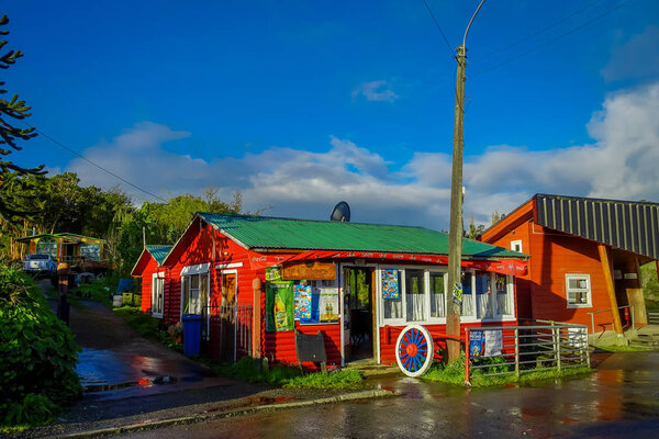 CHILOE, CHILE - SEPTEMBER, 27, 2018: Outdoor view of red wooden market restaurant located in the city of Lemuy located at Chiloe island, south of Chile