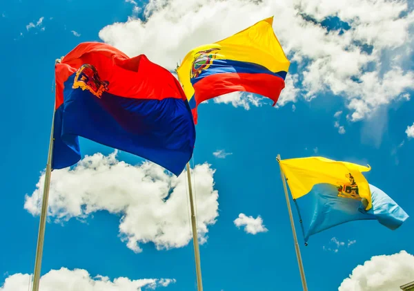 Latacunga, Ecuador, September, 28, 2018: Outdoor view of three flags waving in a gorgeous blue sky background with some clouds in the city of Latacunga — Stock Photo, Image