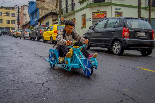 QUITO, ECUADOR - AUGUST 21, 2018: Outdoor view of teenager with glasses riding a tricycle cart in the streets of city of Quito — Stock Photo, Image