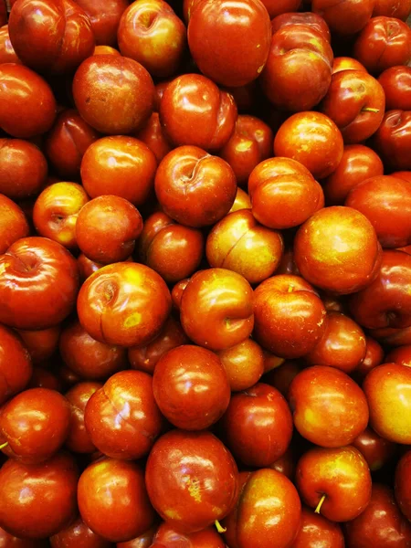 Los verdes maduros rojos se meten en la pila en el mercado . — Foto de Stock