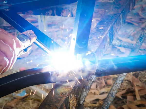 Metal worker doing manual labor, Skilled welder close up.