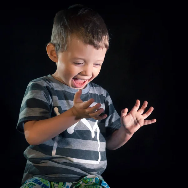 Emotion of a child on a black background .