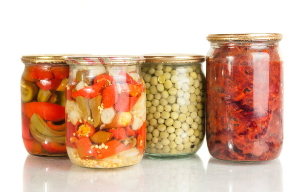 collection set of canned vegetables in glass jars isolated on white background .