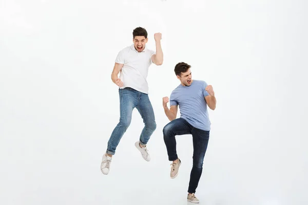 Full Length Portrait Two Happy Young Men Jumping Celebrating Success — Stock Photo, Image