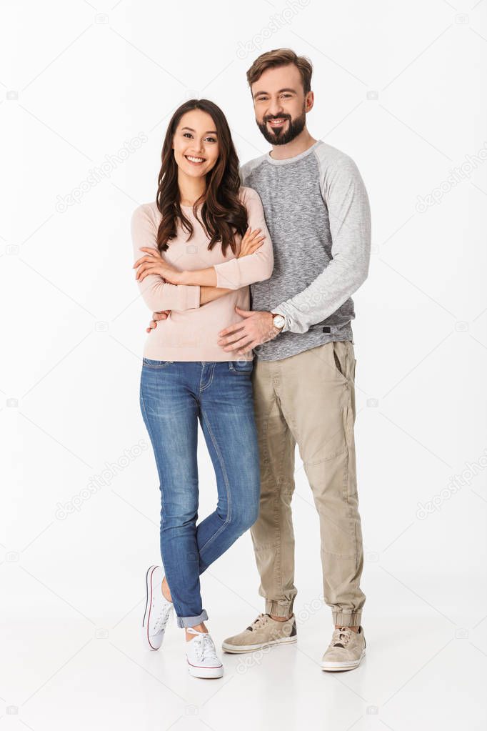 Image of cheerful young loving couple isolated over white wall background. Looking camera.
