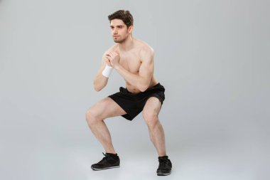 Gri arka plan üzerinde yapıyor kendine güvenen genç yarı çıplak sporcu portresi tam uzunlukta izole ağız kavgası