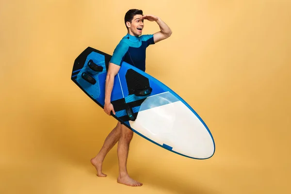 Bild Eines Aufgeregten Jungen Mannes Badeanzug Der Sein Surfbrett Isoliert — Stockfoto