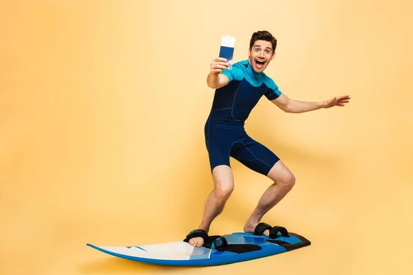 Full Length Portrait Happy Young Man Dressed Swimsuit Showing Passport — Stock Photo, Image