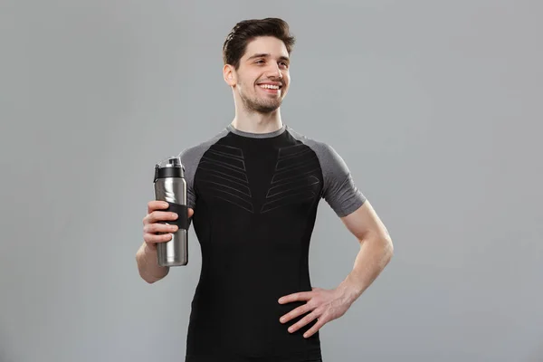Portrait Cheerful Young Sportsman Holding Water Bottle Isolated Gray Background — Stock Photo, Image