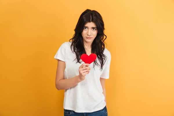 Image Young Sad Woman Standing Isolated Yellow Background Holding Heart — Stock Photo, Image