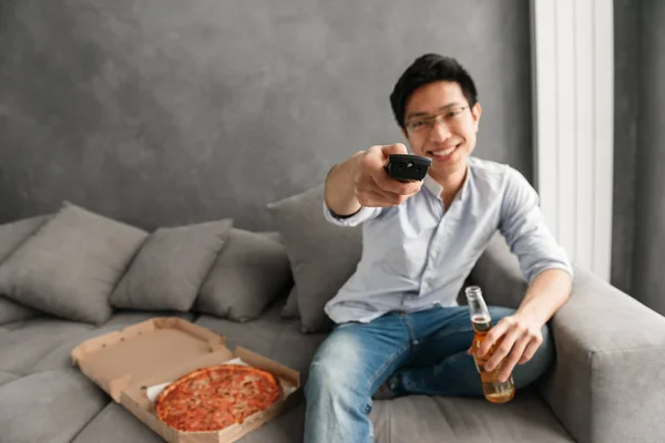 Portrait Happy Young Asian Man Holding Beer Bottle Remote Control — Stock Photo, Image