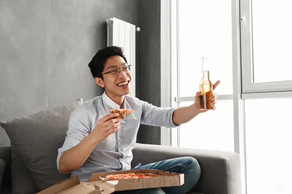 Portrait Laughing Young Asian Man Eating Pizza Drinking Beer While — Stock Photo, Image