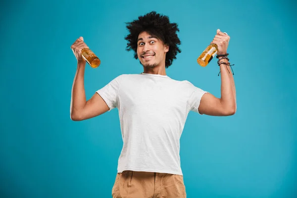 Portrait Happy Young African Man Showing Beer Bottles Isolated Blue — Stock Photo, Image