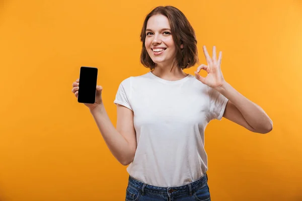 Image Excited Young Woman Standing Isolated Yellow Background Showing Display — Stock Photo, Image