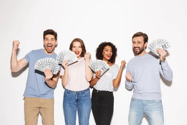 Group of excited multiracial people holding money banknotes and celebrating isolated over white background