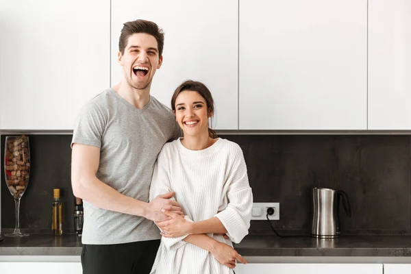 Portrait Cheerful Young Couple Hugging While Standing Kitchen Home — Stock Photo, Image