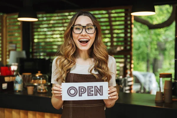 Portrait Excited Young Barista Girl Apron Holding Open Sign Board — Stock Photo, Image