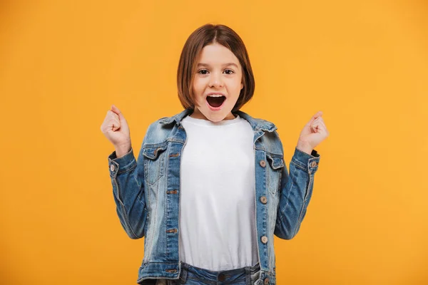 Portrait Happy Little Schoolgirl Celebrating Success Yellow Background — Stock Photo, Image