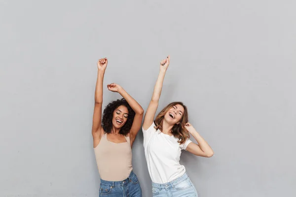 Portrait Two Happy Young Women Dancing Together Isolated Gray Background — Stock Photo, Image
