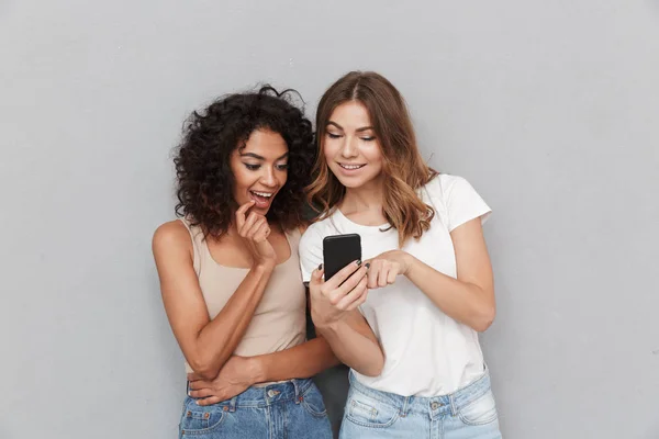 Portret Van Twee Gelukkige Jonge Vrouwen Kijken Naar Mobiele Telefoon — Stockfoto