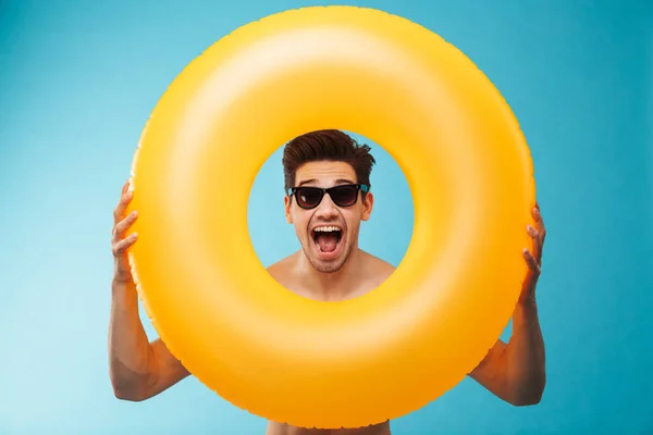 Close Cheerful Man Sunglasses Looking Inflatable Ring Camera Blue Background — Stock Photo, Image