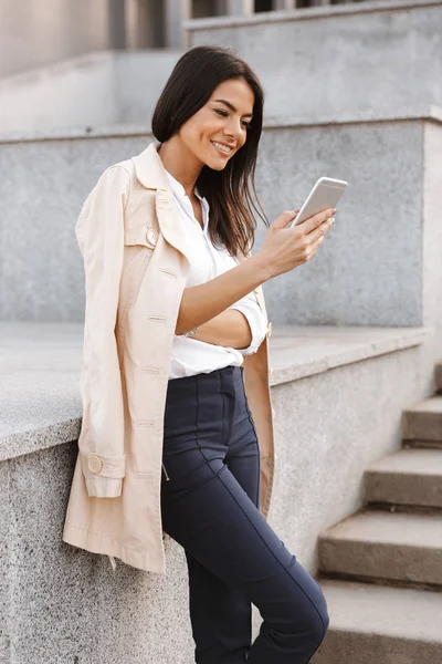 Sorrindo Jovem Mulher Usando Telefone Celular Enquanto Estava Uma Escada — Fotografia de Stock
