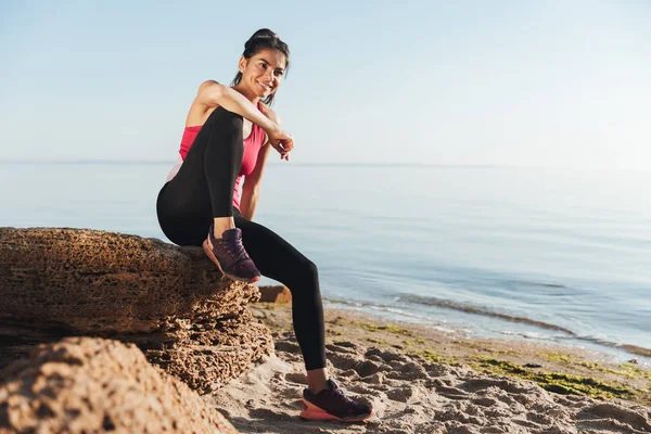 Joven Deportista Sonriente Sentada Una Roca Playa — Foto de Stock