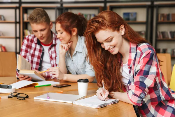 Group Happy Teenagers Doing Homework While Sitting Library Mobile Phone — Stock Photo, Image