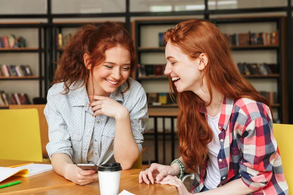 Portrait Two Smiling Teenage Girls Looking Mobile Phone While Sitting — Stock Photo, Image