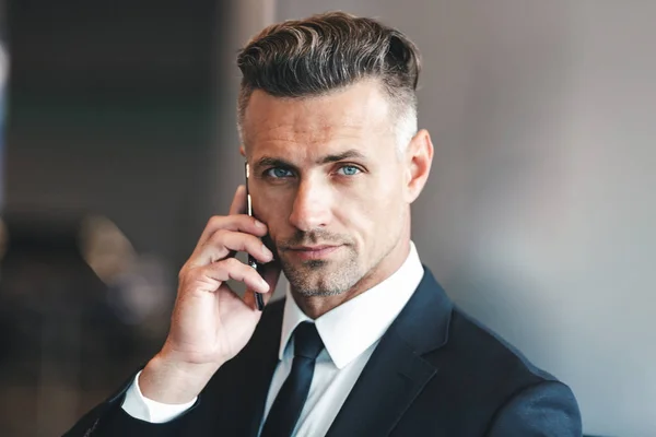 Confident Mature Businessman Talking Mobile Phone While Standing Airport Lobby — Stock Photo, Image