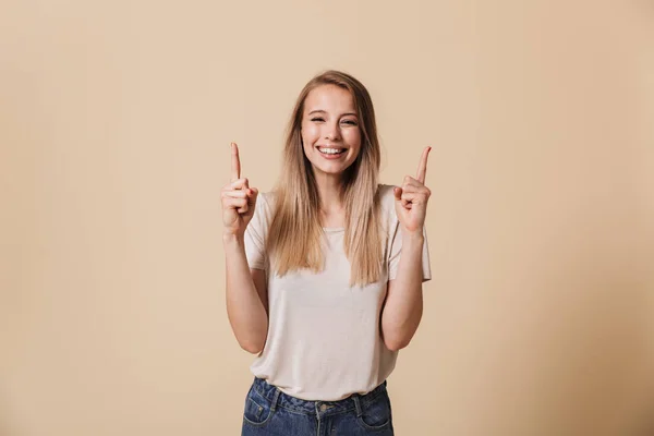 Portrait Cheerful Casual Girl Pointing Finger Copy Space Isolated Beige — Stock Photo, Image