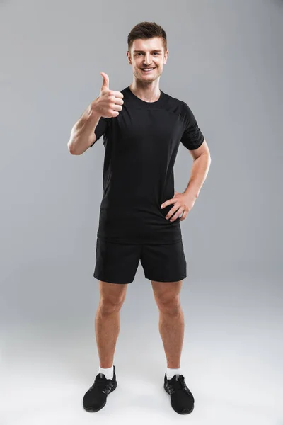 Full Length Portrait Smiling Young Sportsman Showing Thumbs Isolated Gray — Stock Photo, Image