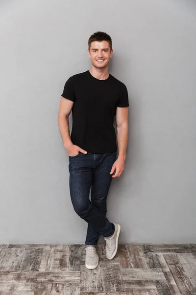 Full Length Portrait Smiling Young Man Looking Camera Gray Background — Stock Photo, Image