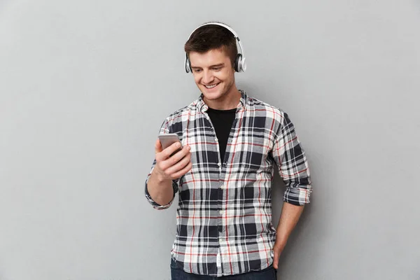 Portrait Cheerful Young Man Listening Music Headphones Holding Mobile Phone — Stock Photo, Image