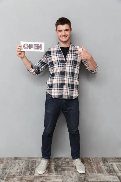 Full Length Portrait Excited Young Man Pointing Finger Board Open — Stock Photo, Image