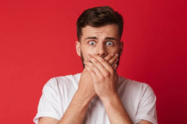 Image Scared Young Man Covering Mouth Hands Standing Isolated Red — Stock Photo, Image