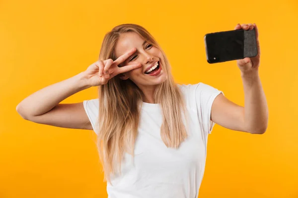 Lovely Young Blonde Girl Showing Peace Gesture While Taking Selfie — Stock Photo, Image